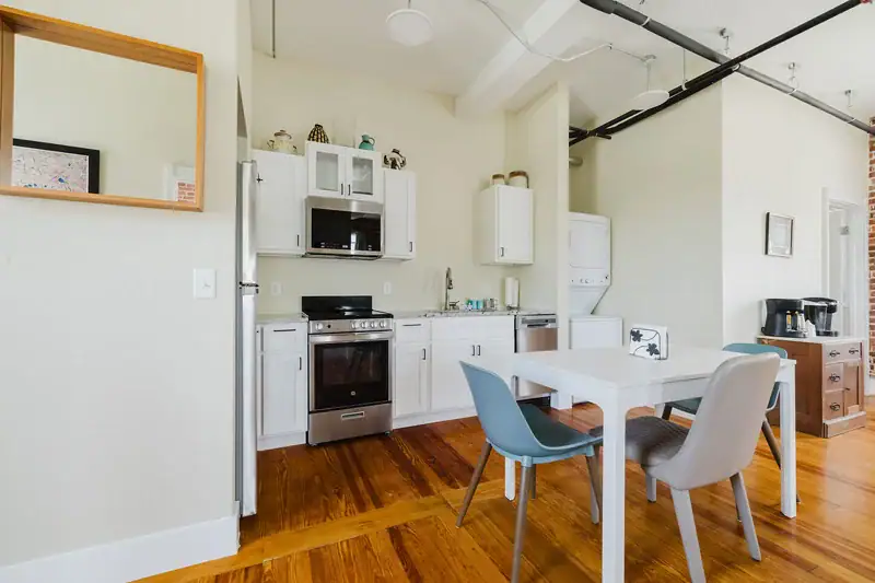 Apt 201 kitchen with dining table and stainless appliances