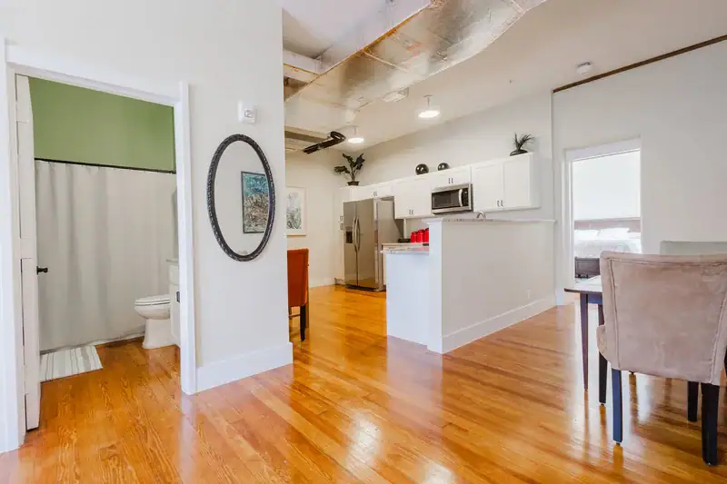 Apartment 303 entry hall with the bathroom and kitchen beyond