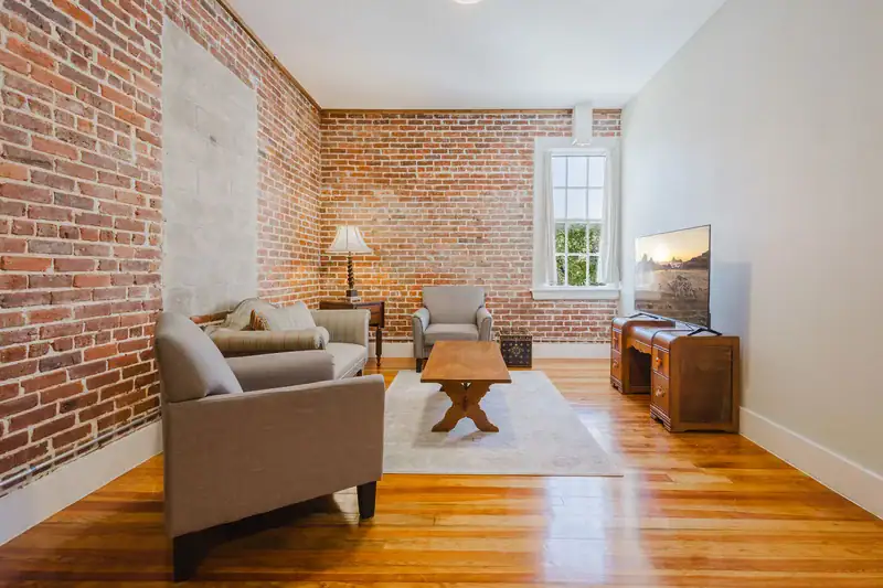 Apartment 303 sitting area with armchairs and window