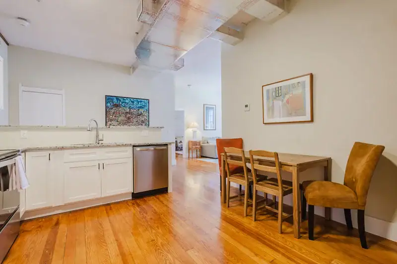 Apartment 303 kitchen counter and dining table with upholstered chairs