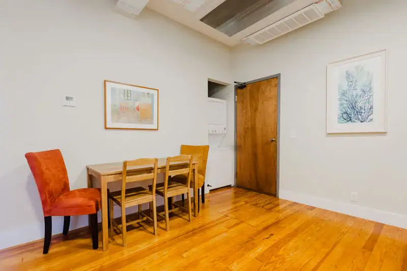 Apartment 303 dining table with orange and gold upholstered chairs