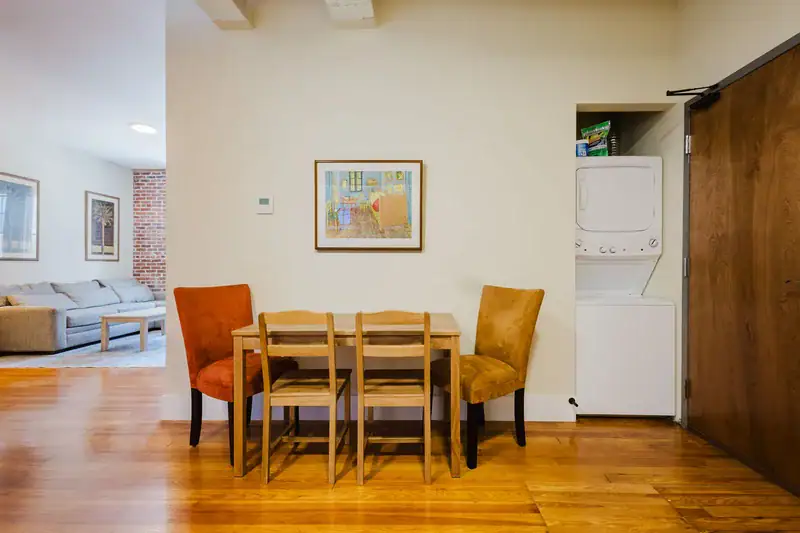 Apartment 303 dining area with in-unit stacked washer and dryer
