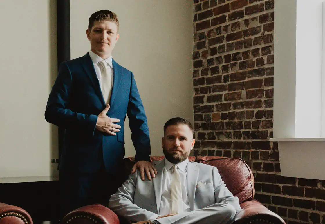 Groom and groomsman in The Parlor seating area